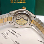 Rolex watch caseback view with gold crown, stainless steel back, two-tone bracelet