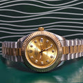 Rolex Day-Date watch with gold dial and diamond hour markers, two-tone gold and steel