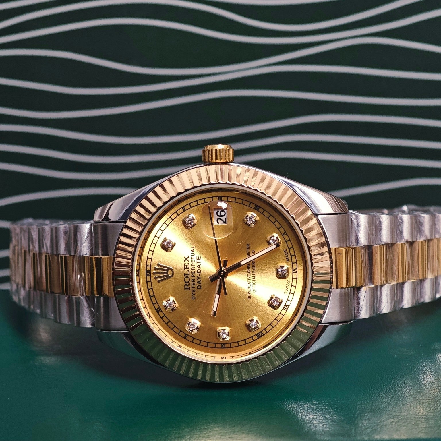 Rolex Day-Date watch with gold dial and diamond hour markers, two-tone gold and steel