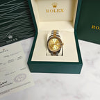 Rolex Day-Date watch with gold dial in two-tone bracelet inside open green presentation box