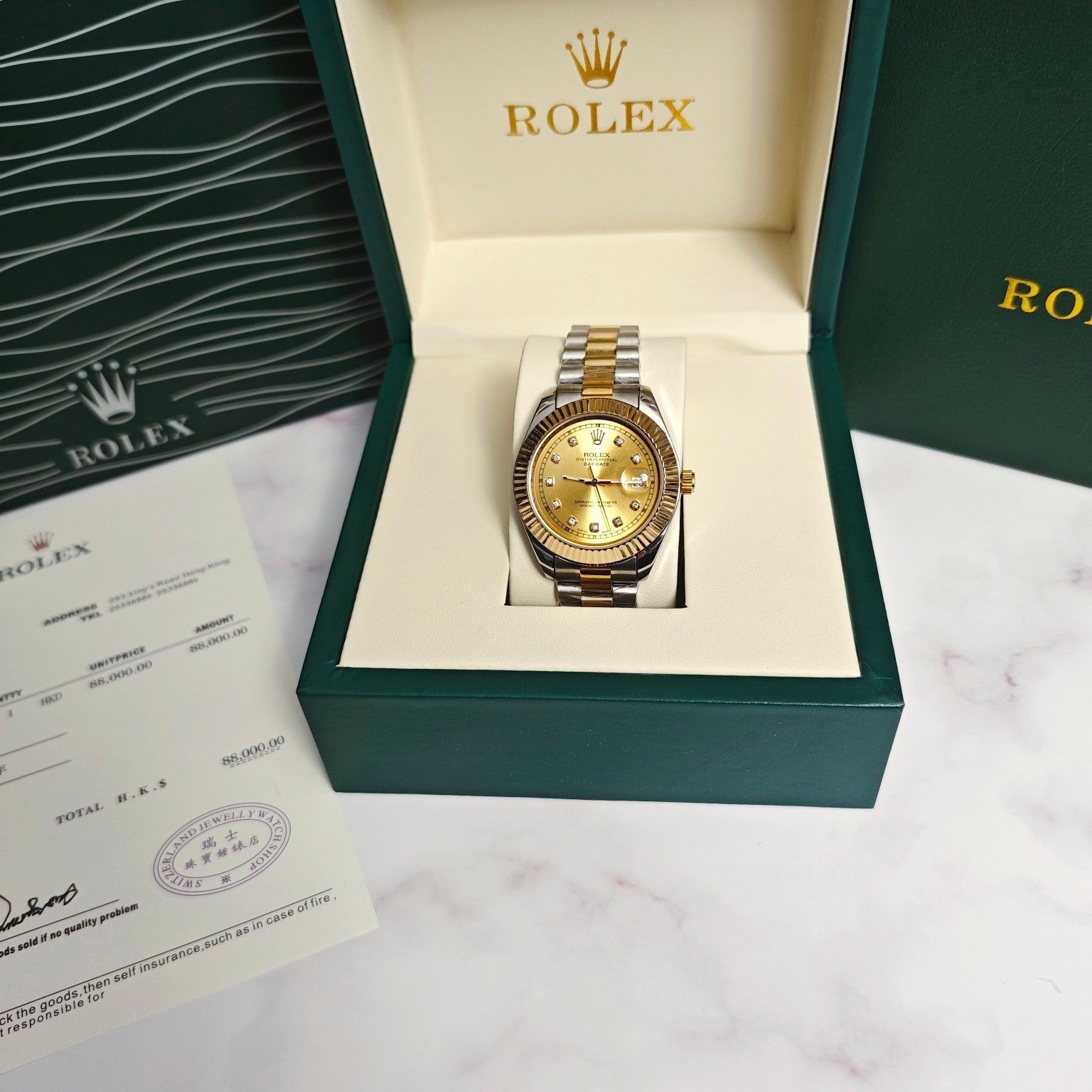 Rolex Day-Date watch with gold dial in two-tone bracelet inside open green presentation box
