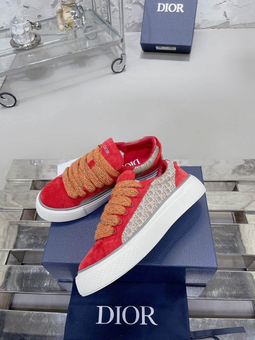 Red suede high-top sneakers, tan rope laces, white sole, Dior branding