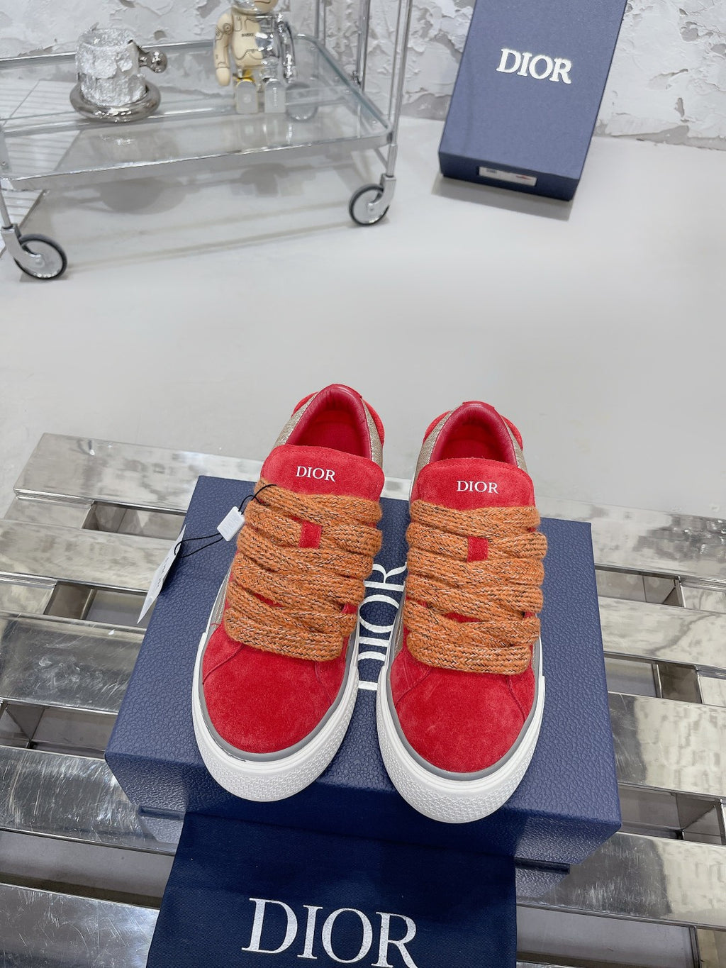 Red suede sneakers, tan rope laces, white sole, Dior logo on heel