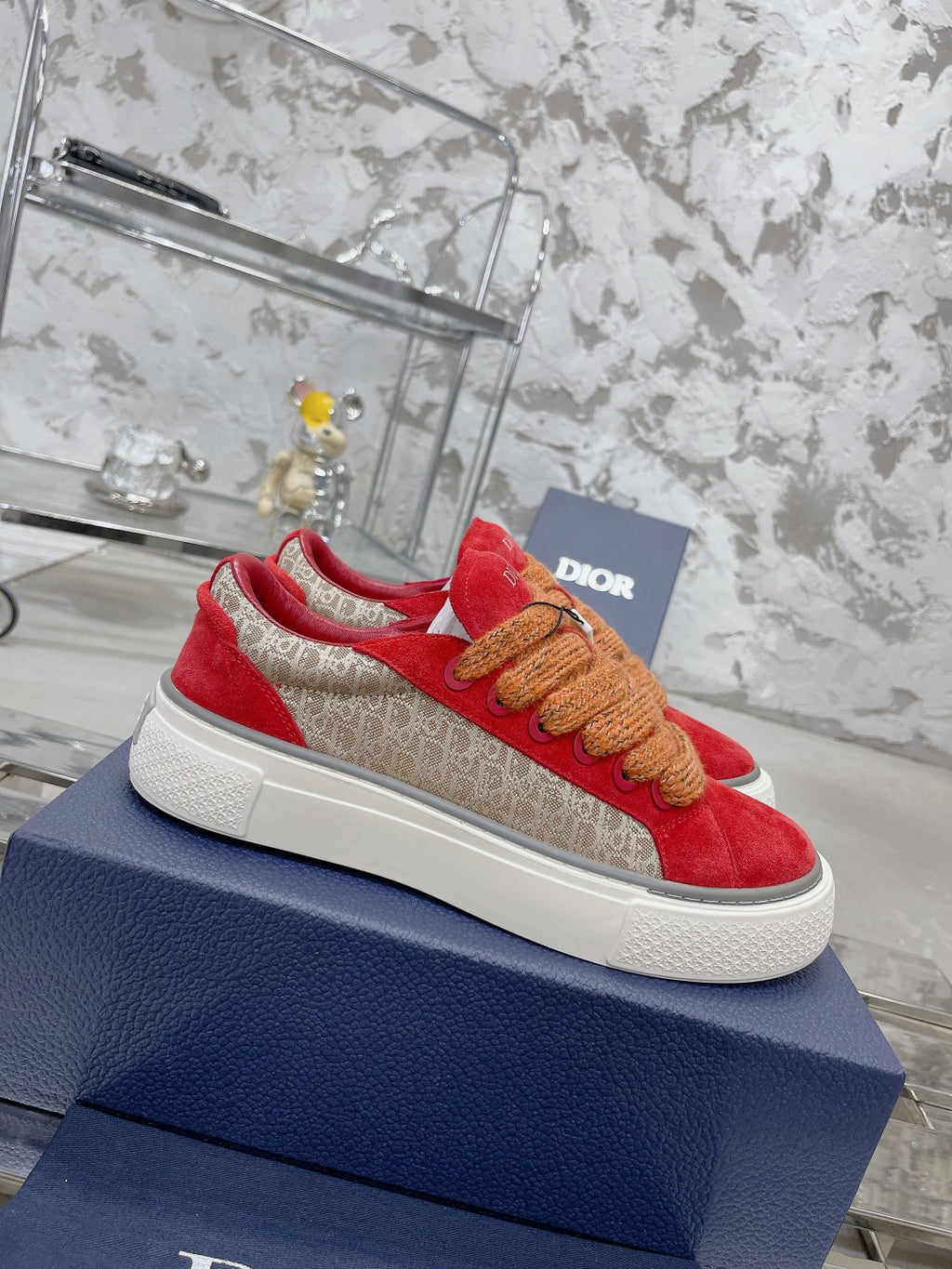 Red suede sneakers with tan rope laces, white sole, Dior logo