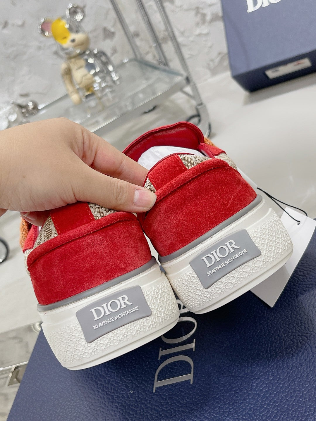 Pair of red suede sneakers with tan rope laces, white soles, Dior tag