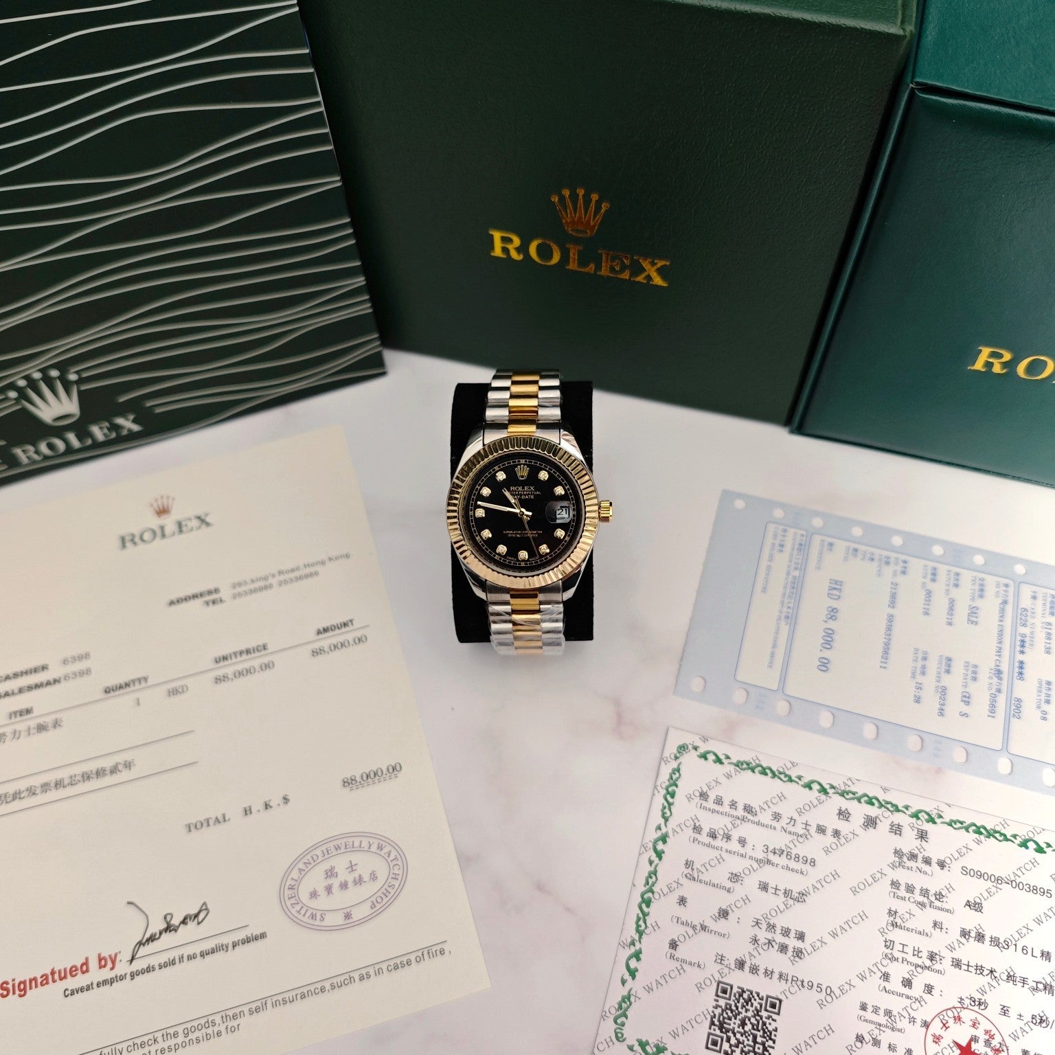 Rolex two-tone wristwatch with black dial, fluted gold bezel, and date window