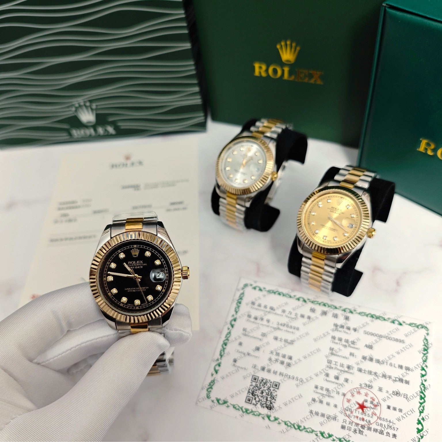 Rolex two-tone wristwatches on display with black dial and gold accents