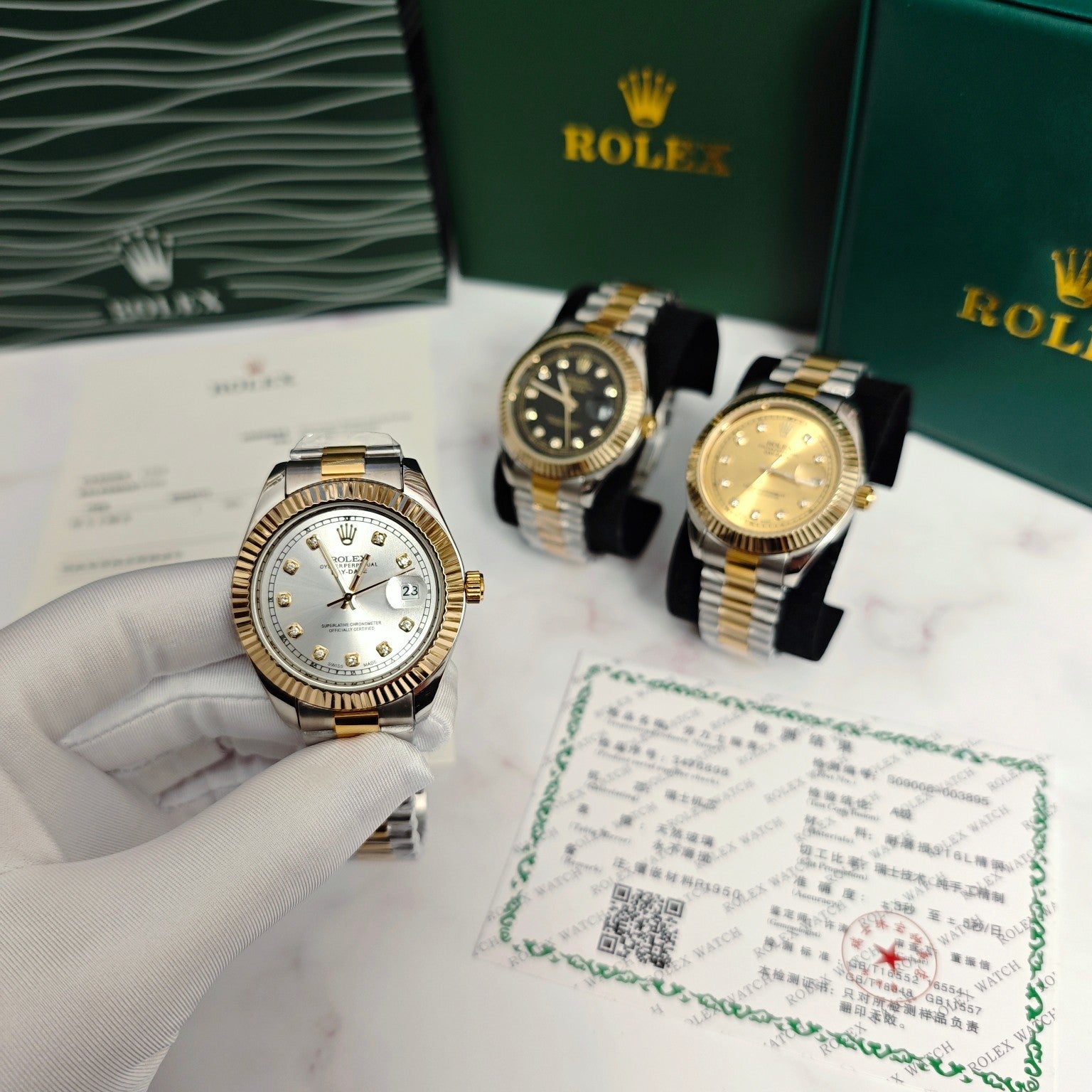 Two-tone Rolex watches on display, silver and gold dials with metal link bands