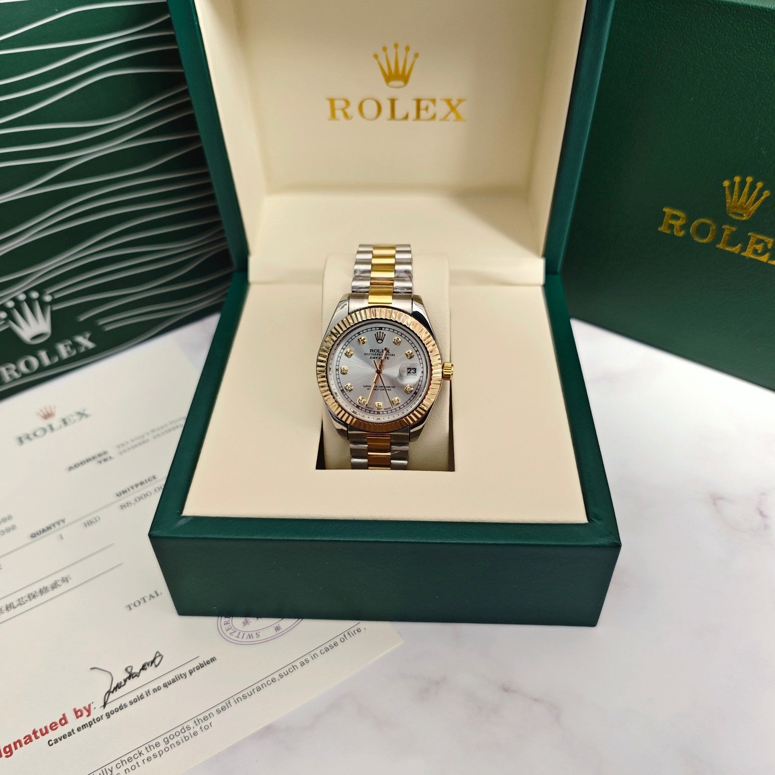 Rolex two-tone wristwatch with silver dial and gold/steel link bracelet in a box