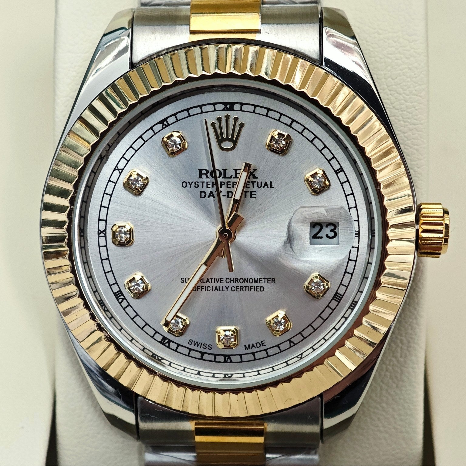 Rolex two-tone dial close-up with gold markers, date window, and gold/steel bezel