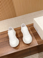 Alexander McQueen white sneakers, pair with lace-up front and ribbed panel details
