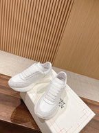 Alexander McQueen white sneakers, lace-up pair with stitched toe and ribbed uppers