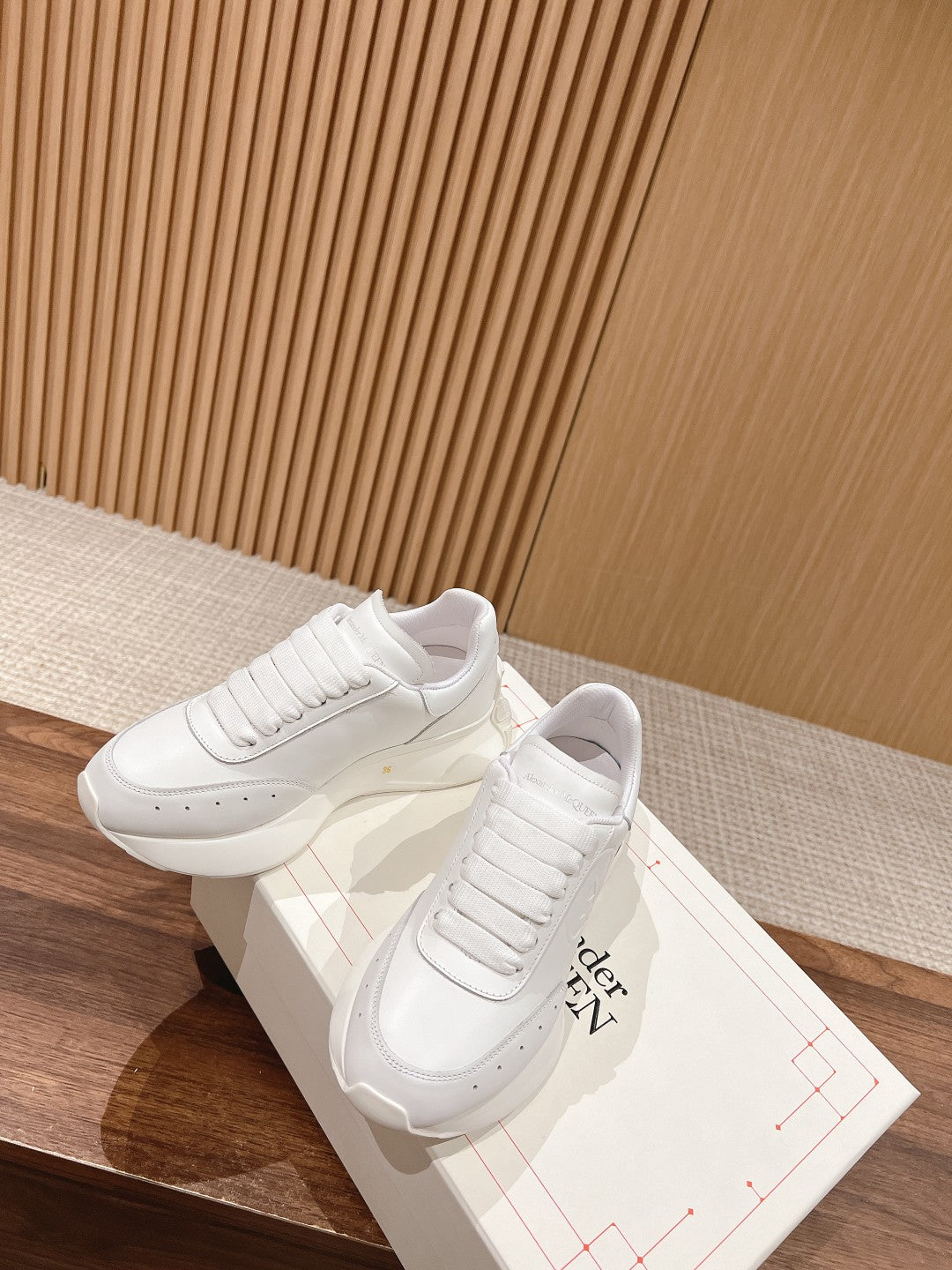 Alexander McQueen white sneakers, lace-up pair with stitched toe and ribbed uppers