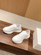 Alexander McQueen white sneakers, lace-up pair with low-profile rubber sole