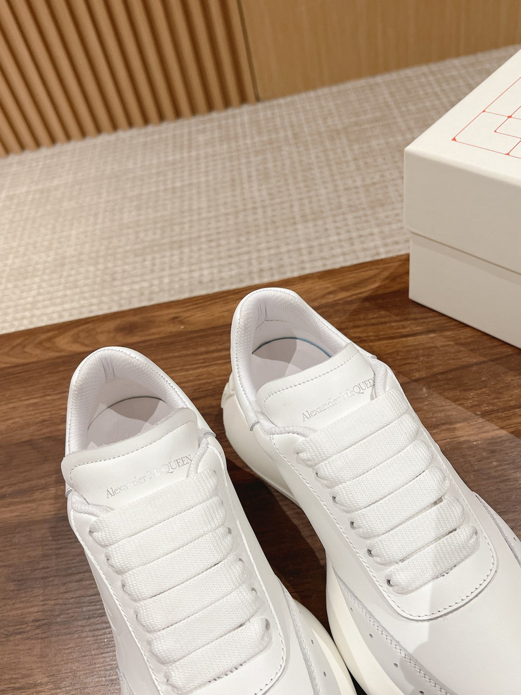 Alexander McQueen white sneakers, close-up of lace-up tongue and padded collar