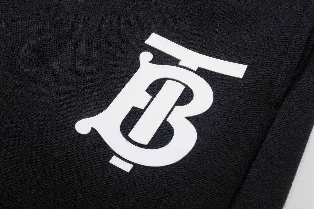 Black pants with oversized white Burberry B logo print