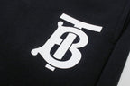 Black pants with oversized white Burberry B logo print