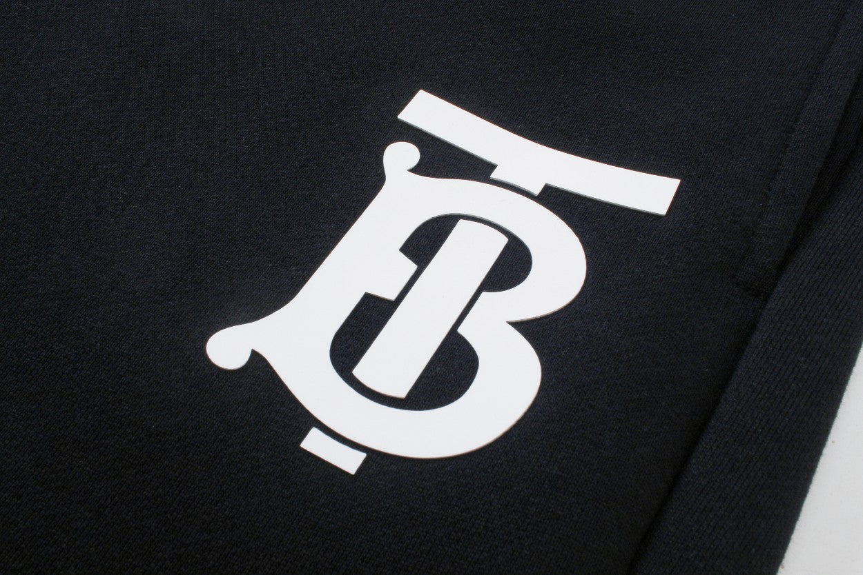 Black pants with oversized white Burberry B logo print