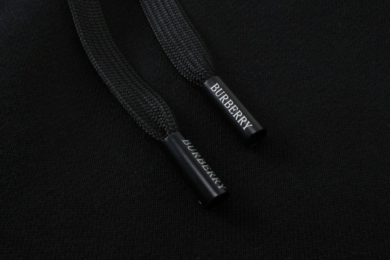 Inside waistband label on black Burberry track pants