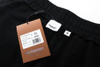 Black jogger pants with size and brand hang tags on waist