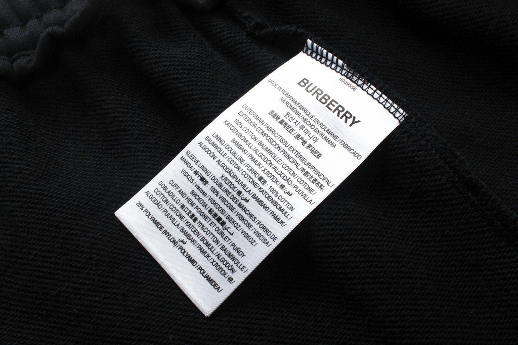 Black Burberry care label and size tag stitched inside pants