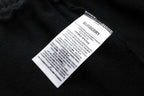 Black Burberry care label and size tag stitched inside pants