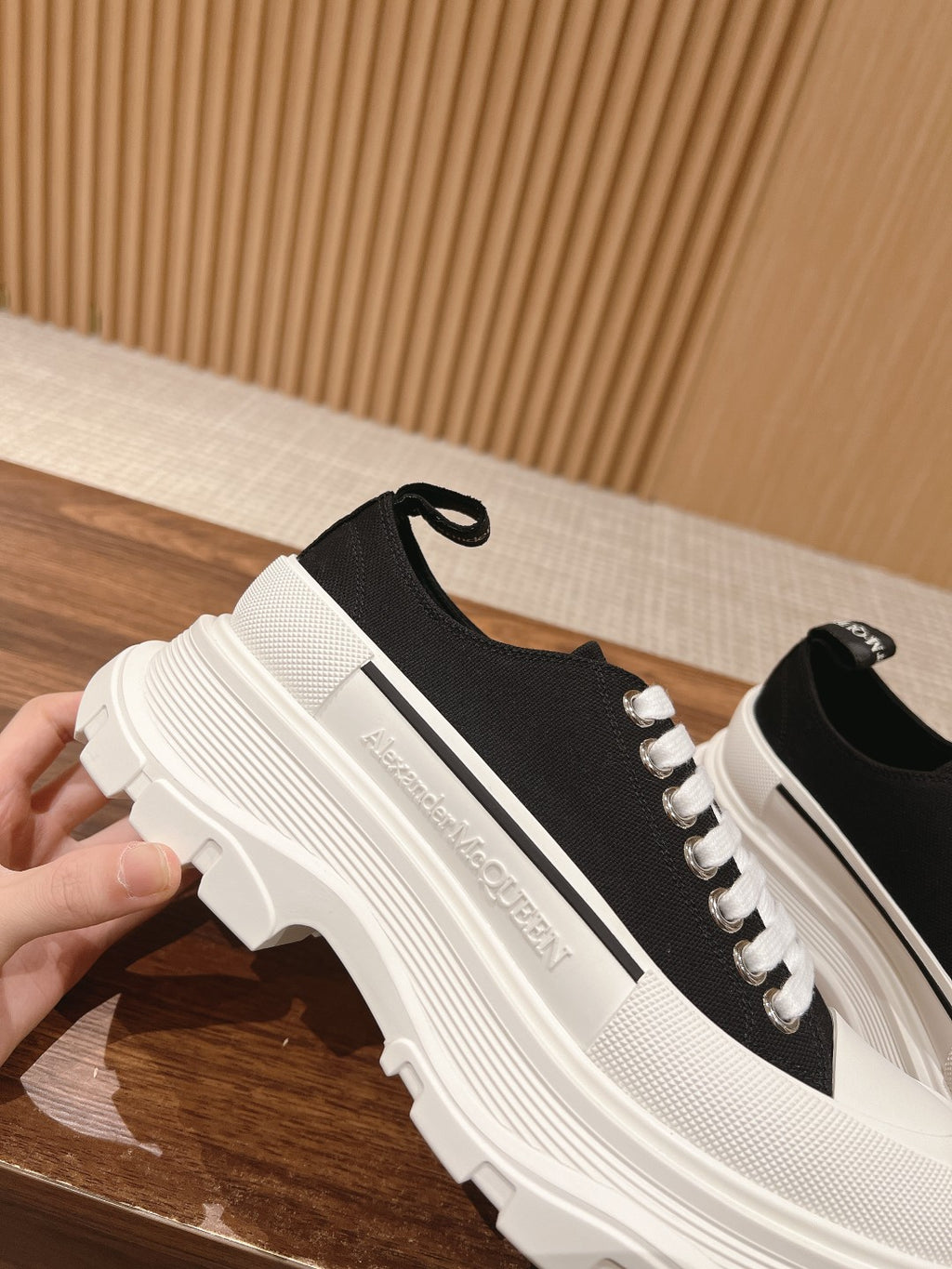 Black and white Alexander McQueen lace-up sneaker, close side profile