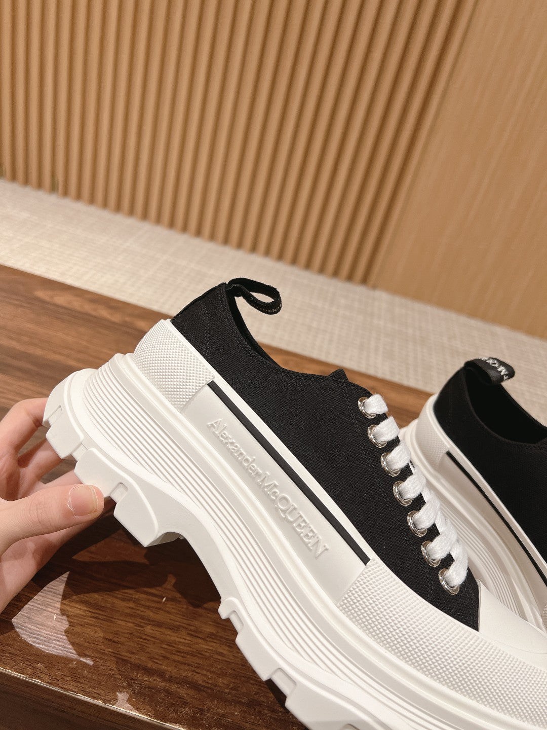 Black and white Alexander McQueen lace-up sneaker, close side profile