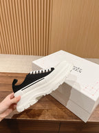 Black and white Alexander McQueen lace-up sneakers with chunky white sole