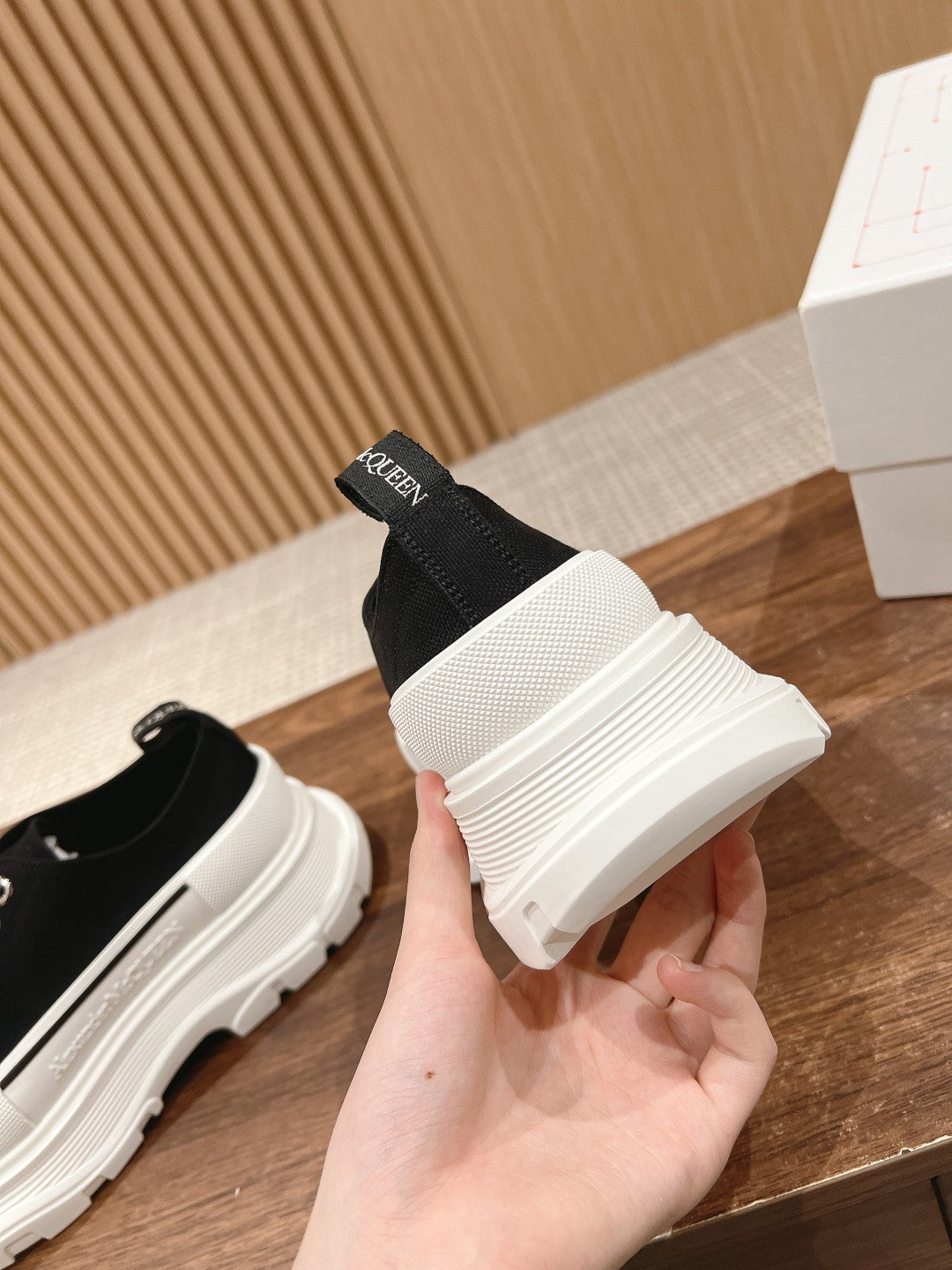 Black Alexander McQueen lace-up sneaker heel detail with white midsole