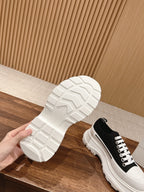 Alexander McQueen sneaker outsole with white treaded sole, black upper