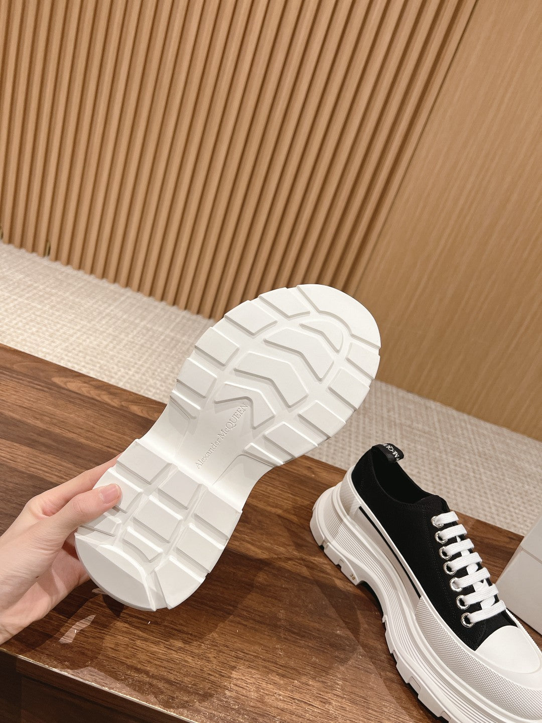 Alexander McQueen sneaker outsole with white treaded sole, black upper