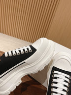 Black and white Alexander McQueen low-top sneaker with white midsole edge