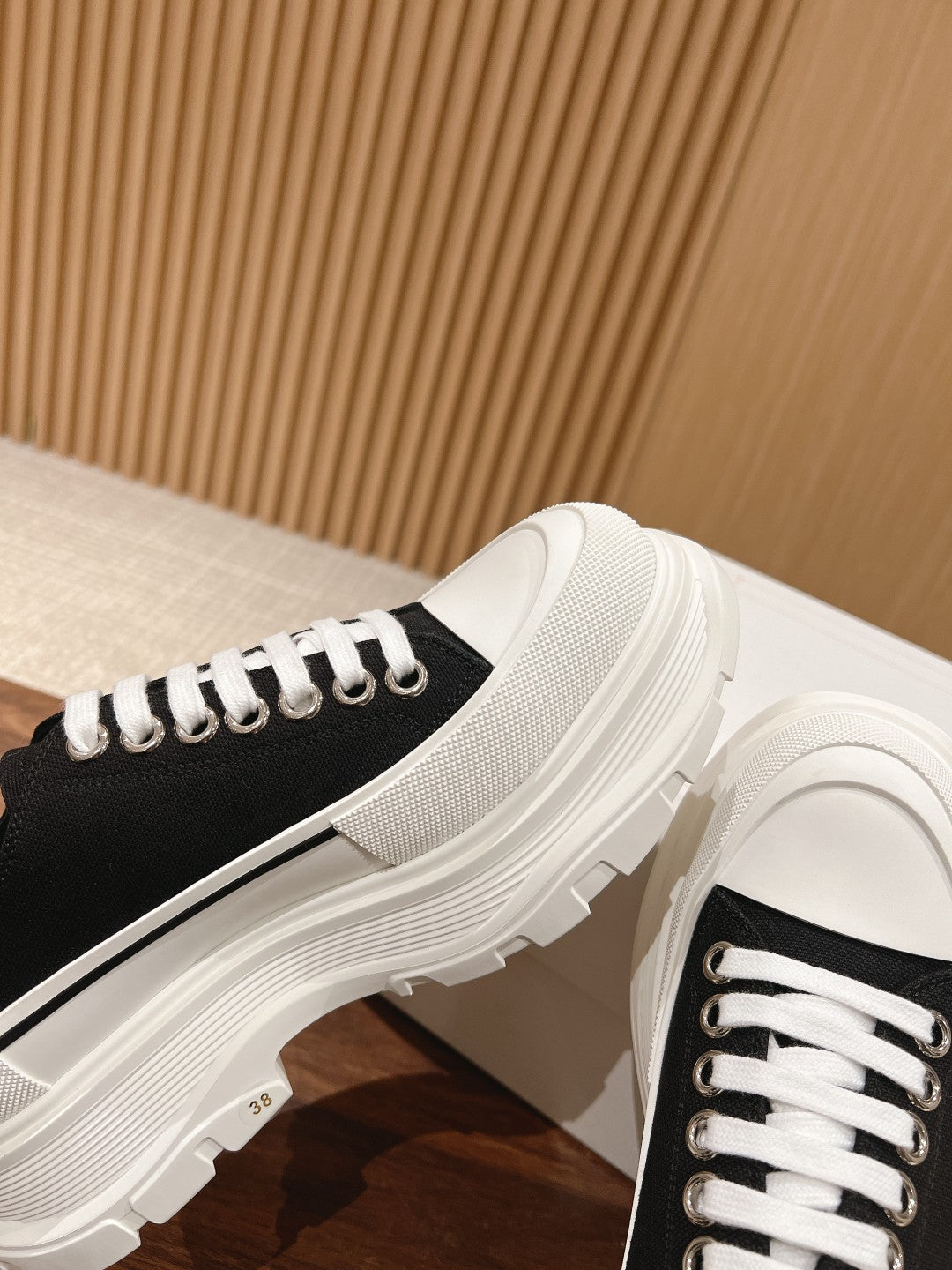 Black and white Alexander McQueen low-top sneaker with white midsole edge