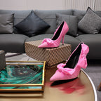 Pink Balenciaga bow sandals with pointed toe and stiletto heel, pair shown
