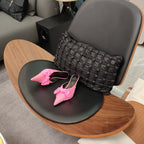 Pink Balenciaga sandals with knotted bow straps and pointed toe, pair on seat