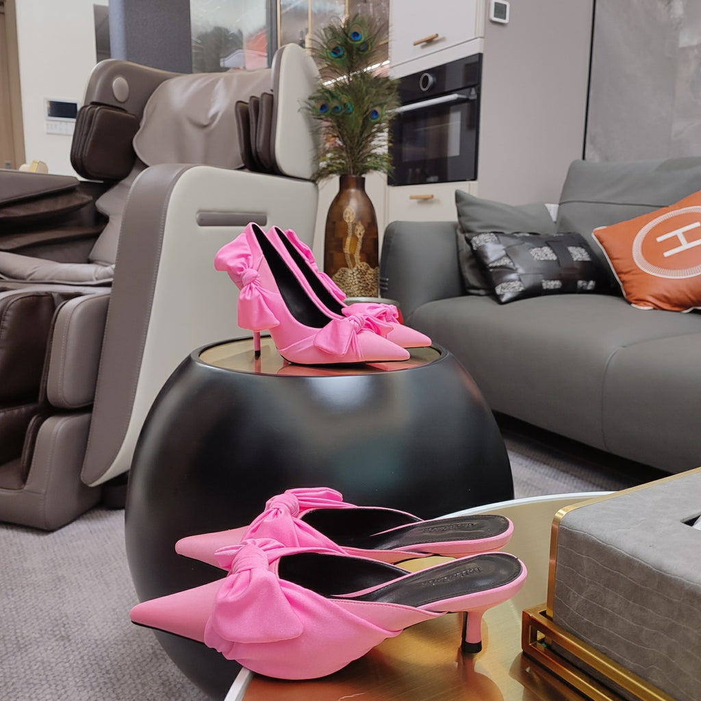 Pink Balenciaga sandals with knotted bow straps and pointed toe, high heel shown