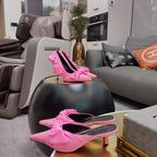 Pink Balenciaga sandals with knotted bow straps and pointed toe, high heel shown