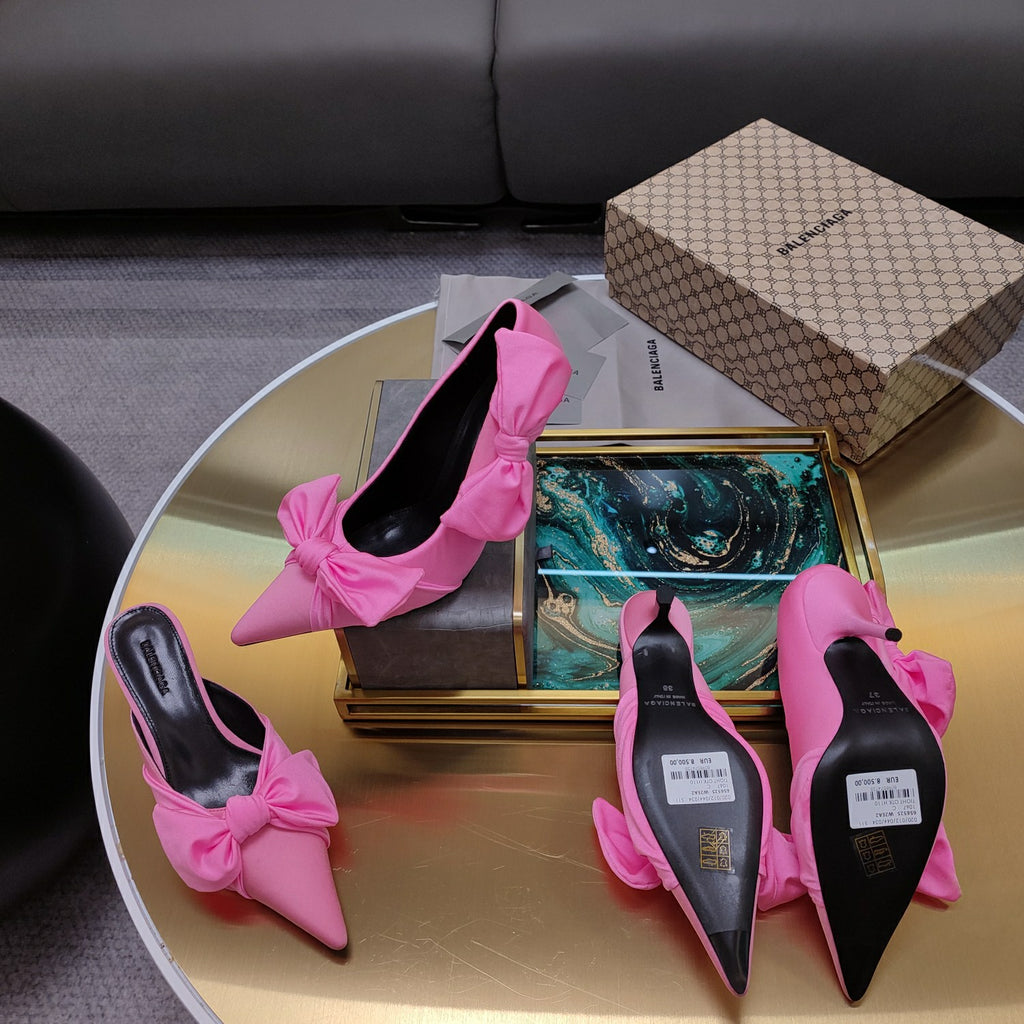 Pink Balenciaga bow sandals with pointed toe and stiletto heel, soles visible