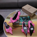 Pink Balenciaga bow sandals with pointed toe and stiletto heel, soles visible