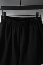 Balenciaga pants in black with elastic waistband and draped leg panels