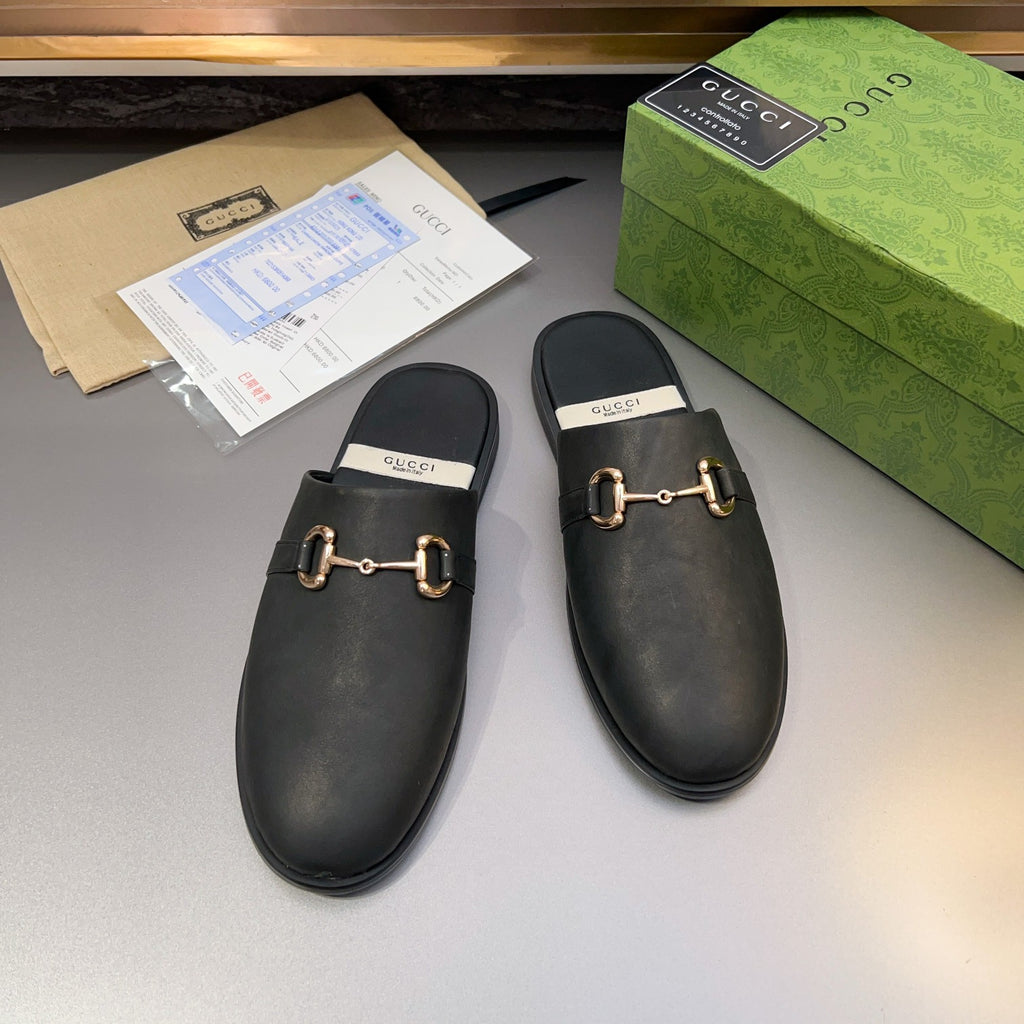 Gucci black leather mule sandals, pair view with gold-tone buckle bar on uppers