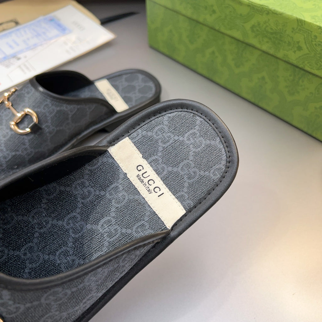 Gucci GG slide sandal with fabric-like insole and gold-tone horsebit hardware, dark upper