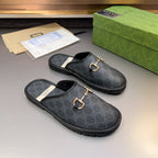 Gucci GG slide sandals with gold-tone horsebit hardware, dark uppers and treaded rubber soles