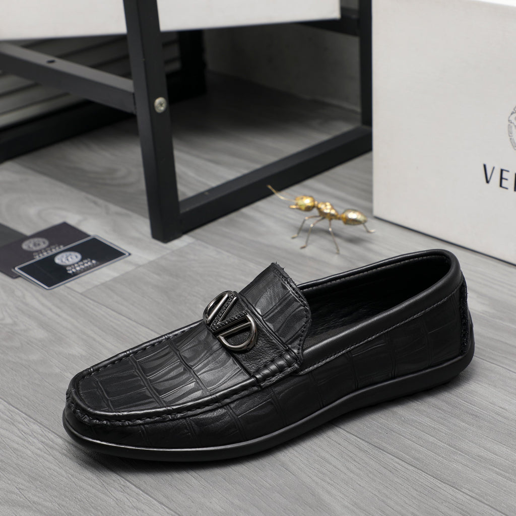 Black leather loafer with embossed texture and metal buckle, low profile side view
