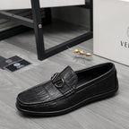 Black leather loafer with embossed texture and metal buckle, low profile side view