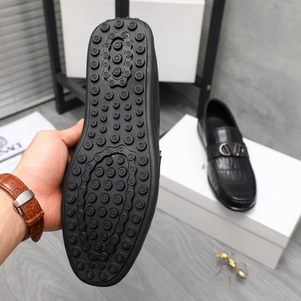 Black loafer outsole with round stud tread and textured traction pattern