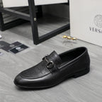 Black leather loafer with side strap buckle and smooth moc toe