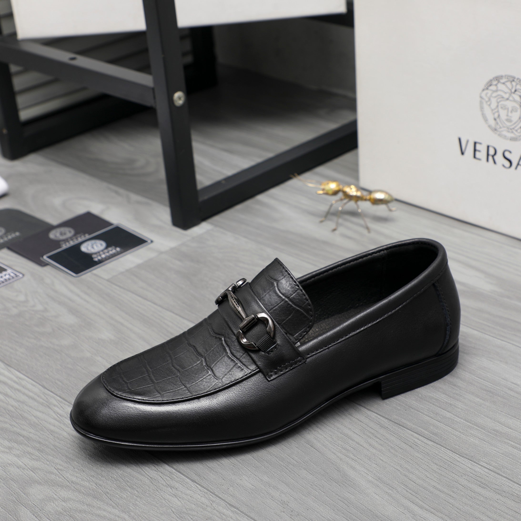 Black leather loafer with side strap buckle and smooth moc toe
