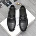 Leather loafer with black crocodile-embossed toe and strap buckle